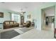 Cozy living room featuring tile floors, neutral walls, comfortable seating, and ample natural light streaming through the window at 3504 Cayugas Loop, St Cloud, FL 34772