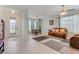 Inviting living room featuring neutral tile flooring, a stylish rug, and a comfortable brown sofa at 3504 Cayugas Loop, St Cloud, FL 34772