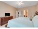 Tranquil main bedroom with a spacious layout, TV, and soothing color palette at 3504 Cayugas Loop, St Cloud, FL 34772