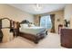 This main bedroom boasts an impressive wooden bed frame, complemented by plush carpeting at 3504 Cayugas Loop, St Cloud, FL 34772