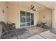 Relaxing covered patio with comfortable seating, ceiling fan, and view of pool and backyard at 3504 Cayugas Loop, St Cloud, FL 34772