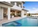 Backyard featuring a pool, spa, covered patio with seating, and view of lake and golf course at 4007 Grande Brick Loop # 13, Orlando, FL 32837