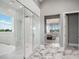 Bright bathroom showcases a glass-enclosed shower, marble floors, and a view of the outside at 4007 Grande Brick Loop # 13, Orlando, FL 32837