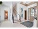 Bright foyer featuring modern art, a staircase with sleek railings, and elegant tile flooring at 4007 Grande Brick Loop # 13, Orlando, FL 32837