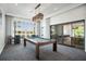 Well-appointed game room featuring a pool table, stylish seating, and ample natural light at 4007 Grande Brick Loop # 13, Orlando, FL 32837