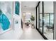 Bright hallway leading to dining area with tile floors, art on walls, and view of golf course at 4007 Grande Brick Loop # 13, Orlando, FL 32837