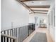 Hallway with exposed beam ceiling and black iron railing at 4007 Grande Brick Loop # 13, Orlando, FL 32837