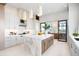 Bright, modern kitchen with marble island, pendant lights, and a seamless flow to the outdoor living space at 4007 Grande Brick Loop # 13, Orlando, FL 32837