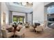 Bright seating area featuring fireplace, open floor plan, modern light fixture, and views of outdoor pool at 4007 Grande Brick Loop # 13, Orlando, FL 32837