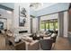 Spacious living room featuring modern fireplace, neutral tones, high ceilings, and views of outdoor pool at 4007 Grande Brick Loop # 13, Orlando, FL 32837
