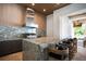 Granite countertops accent this outdoor kitchen featuring bar seating and stainless steel grill at 4007 Grande Brick Loop # 13, Orlando, FL 32837