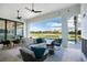 Outdoor living area with plush seating, dining table, ceiling fans, and a view of the lush golf course at 4007 Grande Brick Loop # 13, Orlando, FL 32837