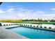 Stunning pool with a water view overlooking a beautifully landscaped golf course on a sunny day at 4007 Grande Brick Loop # 13, Orlando, FL 32837