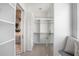 Organized walk-in closet with custom shelving, bench seating, and easy access to the bathroom at 4007 Grande Brick Loop # 13, Orlando, FL 32837