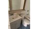 Bathroom featuring a gray vanity with tub and toilet with blue tiled floors at 41 Sunset Cir, Lake Alfred, FL 33850