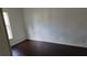 This bedroom features wood-look floors and white paneling at 41 Sunset Cir, Lake Alfred, FL 33850