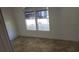 Bedroom with neutral-toned vinyl flooring and white paneled walls at 41 Sunset Cir, Lake Alfred, FL 33850