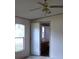 Bedroom with ceiling fan and an open door to the bathroom at 41 Sunset Cir, Lake Alfred, FL 33850