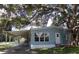 Charming single-story home with a covered parking area and mature tree providing shade at 41 Sunset Cir, Lake Alfred, FL 33850