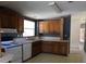 Traditional kitchen featuring wood cabinets, white appliances, and a window over the sink at 41 Sunset Cir, Lake Alfred, FL 33850