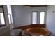 Bathroom with a corner soaking tub and natural light from the three small vertical windows at 41 Sunset Cir, Lake Alfred, FL 33850