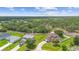 Aerial view of home highlighting the community, peaceful surroundings, lush landscaping, and mature trees at 412 Mallard Way, Kissimmee, FL 34759