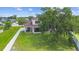 Expansive backyard with lush green grass, screened lanai and a charming old oak tree in a fenced yard at 412 Mallard Way, Kissimmee, FL 34759