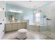 Bright bathroom features a glass enclosed shower and a soaking tub at 412 Mallard Way, Kissimmee, FL 34759