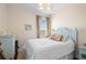 Comfortable bedroom featuring a cozy bed, side table, dresser, and closet at 412 Mallard Way, Kissimmee, FL 34759