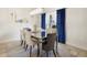 Elegant dining room featuring a mirrored table, stylish chairs, and bright natural light at 412 Mallard Way, Kissimmee, FL 34759