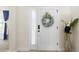 Bright entryway featuring a classic white door adorned with a decorative wreath at 412 Mallard Way, Kissimmee, FL 34759