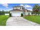 Charming two-story home with a well-manicured lawn and a spacious driveway at 412 Mallard Way, Kissimmee, FL 34759