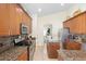 Well-equipped kitchen with granite countertops, stainless steel appliances, and wooden cabinetry at 412 Mallard Way, Kissimmee, FL 34759