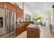 Bright kitchen with stainless steel appliances, wooden cabinets, and a breakfast nook at 412 Mallard Way, Kissimmee, FL 34759