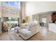 Bright living room with two-story ceilings, neutral decor, and a view of the backyard at 412 Mallard Way, Kissimmee, FL 34759