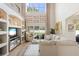 Bright living room with two-story ceilings, neutral decor, and a view of the backyard at 412 Mallard Way, Kissimmee, FL 34759