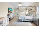 Bright primary bedroom boasting a four-poster bed, modern decor, and tile floors at 412 Mallard Way, Kissimmee, FL 34759