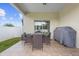Covered patio features a dining set and grill perfect for outdoor meals at 412 Mallard Way, Kissimmee, FL 34759