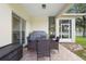 Covered patio features a dining set and grill perfect for outdoor meals at 412 Mallard Way, Kissimmee, FL 34759