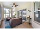 Screened lanai with neutral tiling and fan is furnished with comfortable seating at 412 Mallard Way, Kissimmee, FL 34759