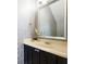 Stylish powder room featuring patterned wallpaper, modern fixtures, and designer mirror at 412 Mallard Way, Kissimmee, FL 34759