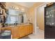Bathroom featuring double sinks, granite countertops, wooden cabinets, and a separate toilet area at 425 Sterling Lake Dr, Ocoee, FL 34761