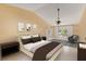 Bright bedroom featuring neutral paint, ceiling fan, and windows with lots of natural light at 425 Sterling Lake Dr, Ocoee, FL 34761