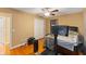 Comfortable bedroom featuring wood floors, ceiling fan, and TV for relaxation and entertainment at 425 Sterling Lake Dr, Ocoee, FL 34761