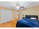 Inviting bedroom features a ceiling fan, closet, and hardwood floors for a cozy ambiance at 425 Sterling Lake Dr, Ocoee, FL 34761