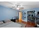 Bedroom with a ceiling fan, hardwood floors, closet, and bikes for exercise enthusiasts at 425 Sterling Lake Dr, Ocoee, FL 34761
