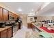 Well lit kitchen with granite countertops, stainless steel appliances, and dark wood cabinets at 425 Sterling Lake Dr, Ocoee, FL 34761