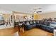Spacious living room connected to the kitchen with a large sectional sofa and hardwood flooring at 425 Sterling Lake Dr, Ocoee, FL 34761