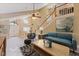 Bright living room boasts high ceilings, staircase, stylish furnishings, and modern decor at 425 Sterling Lake Dr, Ocoee, FL 34761