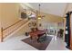 Spacious living area featuring a billiard table, staircase, and sliding doors to the backyard at 425 Sterling Lake Dr, Ocoee, FL 34761